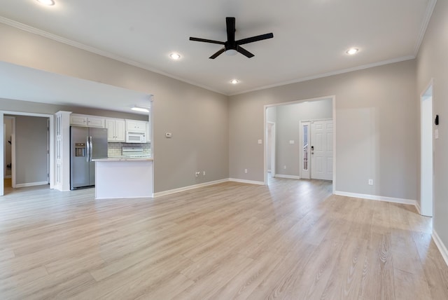 unfurnished living room featuring ceiling fan, ornamental molding, and light wood-type flooring