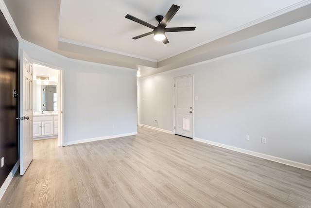 unfurnished room with crown molding, ceiling fan, a raised ceiling, and light hardwood / wood-style floors