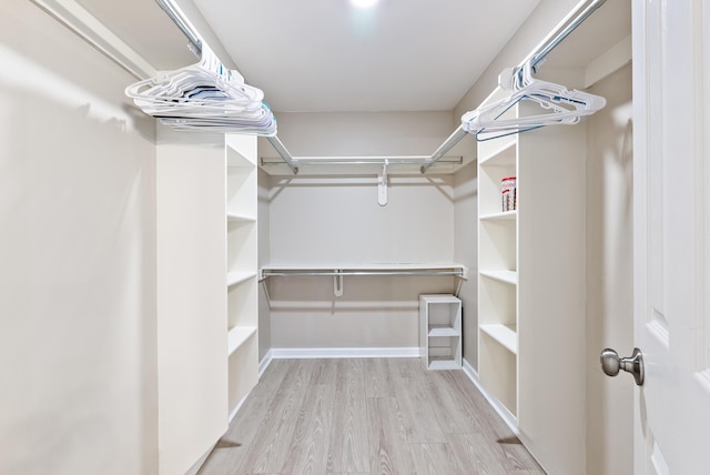 walk in closet featuring light hardwood / wood-style flooring