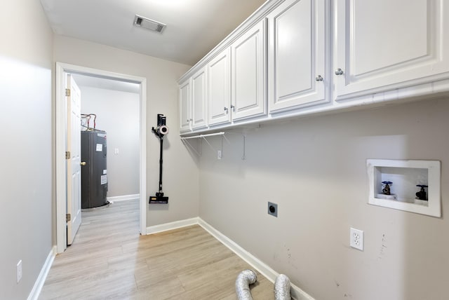 laundry room featuring water heater, hookup for an electric dryer, cabinets, and light hardwood / wood-style floors