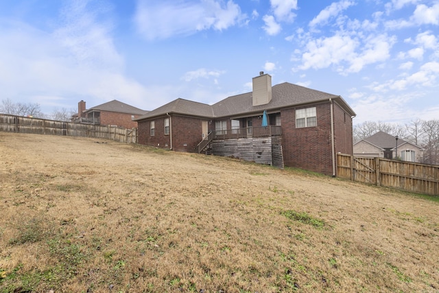 rear view of property with a lawn