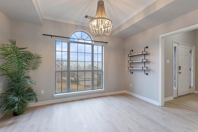 interior space with crown molding, a notable chandelier, and light wood-type flooring