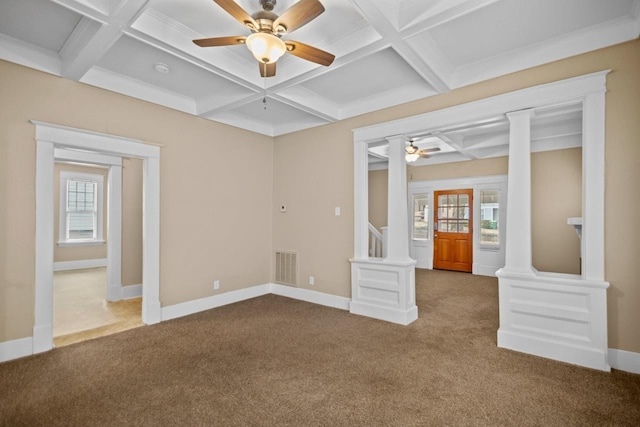 unfurnished room with coffered ceiling, ornate columns, carpet flooring, and a wealth of natural light