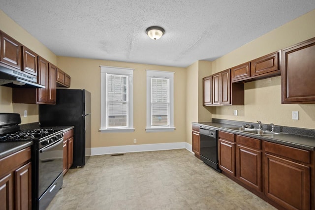 kitchen featuring sink, a textured ceiling, and black appliances