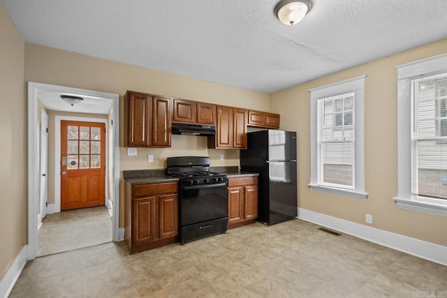 kitchen with black appliances and a textured ceiling