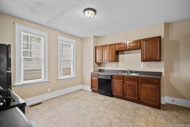 kitchen with sink, black appliances, and a textured ceiling