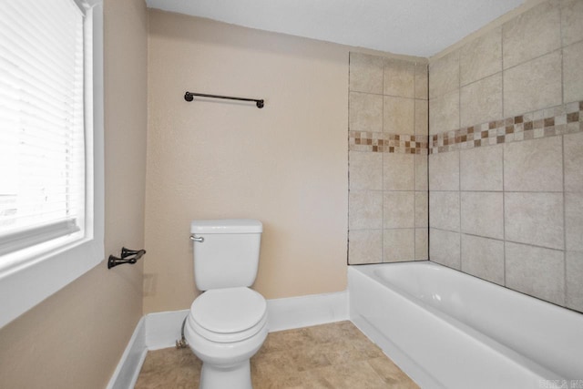 bathroom with toilet and tile patterned flooring