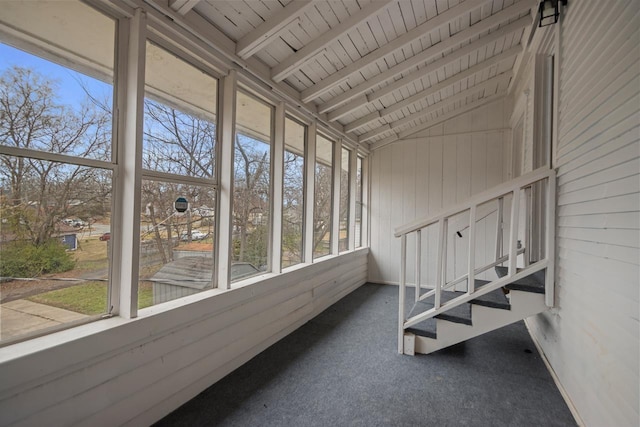 unfurnished sunroom featuring wooden ceiling and vaulted ceiling with beams