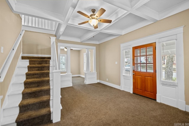 carpeted foyer with coffered ceiling, beam ceiling, ceiling fan, and ornate columns