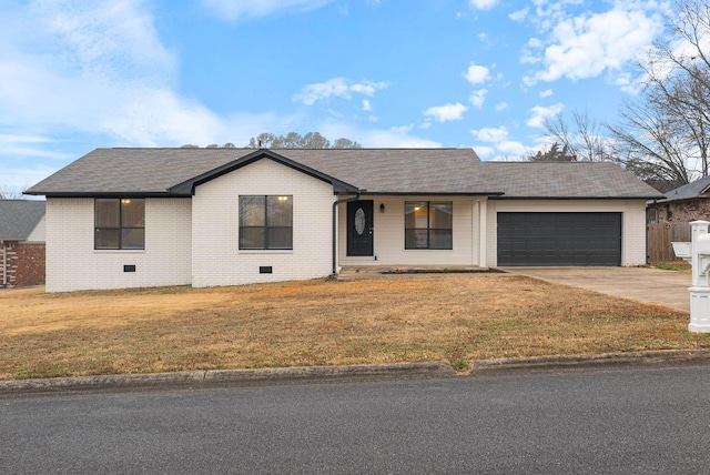 ranch-style house featuring a garage and a front yard