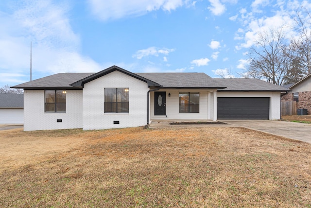 ranch-style home with a garage and a front yard