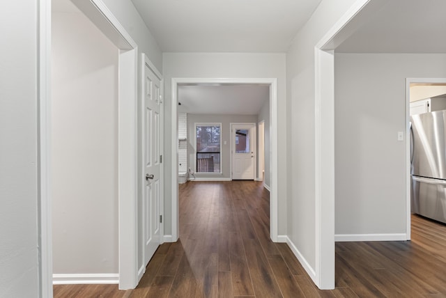 corridor with dark hardwood / wood-style floors