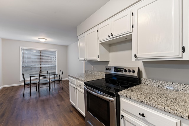 kitchen with white cabinetry, dark hardwood / wood-style flooring, light stone counters, and stainless steel range with electric cooktop