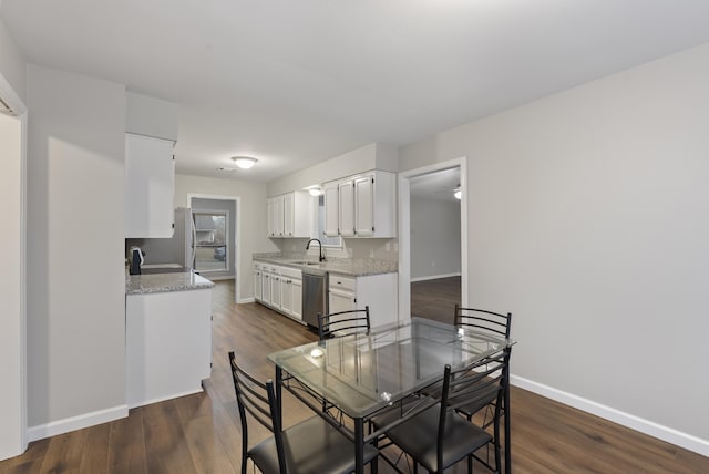 dining space featuring dark hardwood / wood-style floors and sink