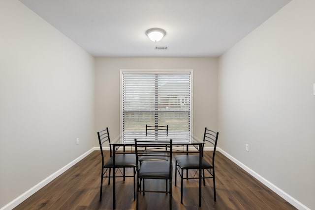 dining room with dark wood-type flooring