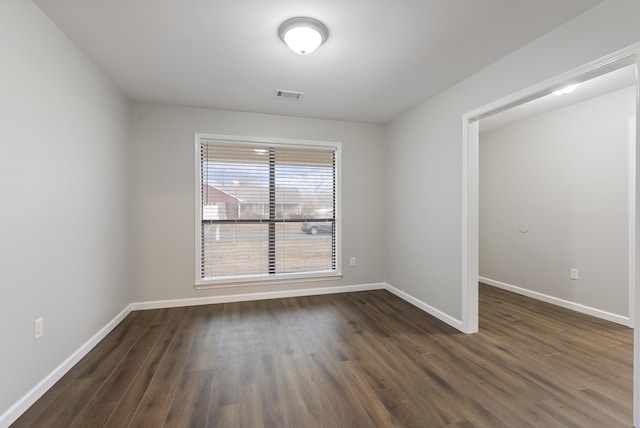 empty room featuring dark hardwood / wood-style flooring