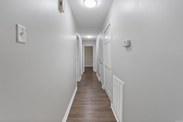 corridor featuring dark hardwood / wood-style floors