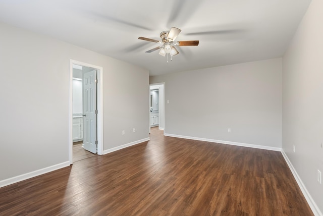 spare room featuring ceiling fan and dark hardwood / wood-style flooring