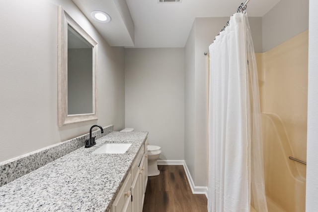 bathroom with vanity, hardwood / wood-style floors, curtained shower, and toilet