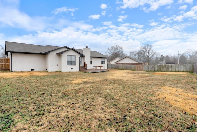 rear view of property featuring a yard