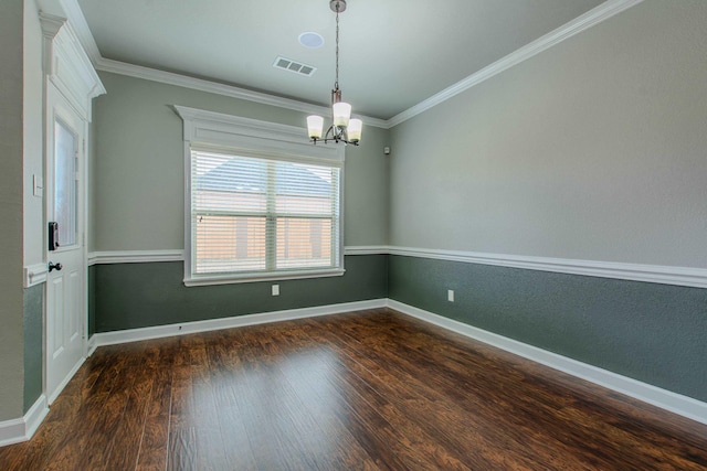 empty room with ornamental molding, a chandelier, and dark hardwood / wood-style flooring