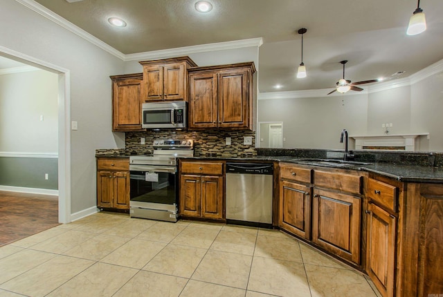 kitchen with light tile patterned flooring, sink, dark stone counters, stainless steel appliances, and backsplash