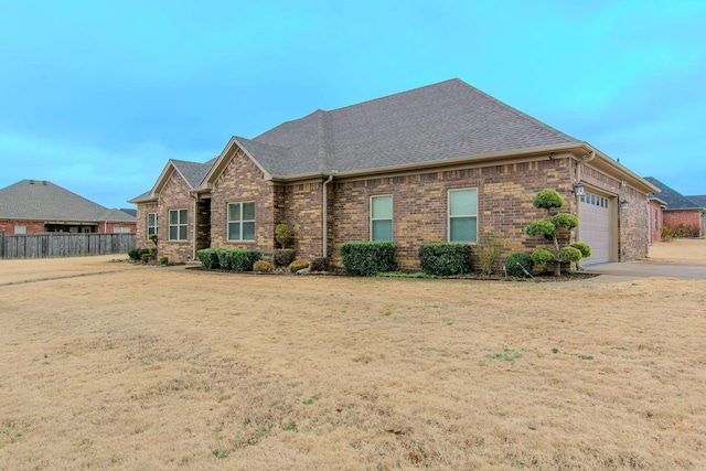 view of front of property featuring a garage and a front yard