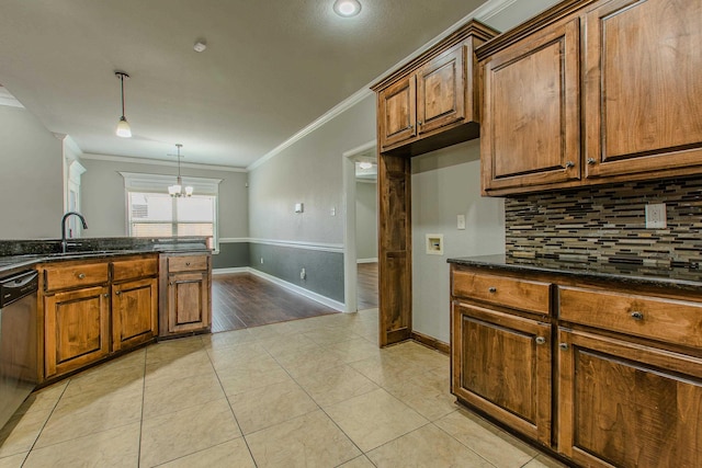 kitchen featuring dark stone countertops, ornamental molding, dishwasher, and light tile patterned flooring