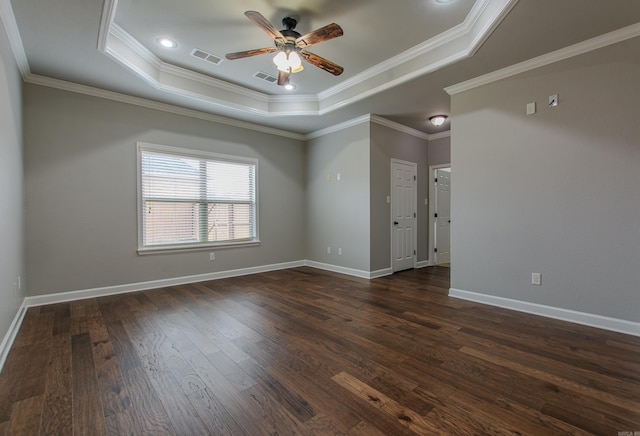 unfurnished room with crown molding, dark wood-type flooring, ceiling fan, and a tray ceiling