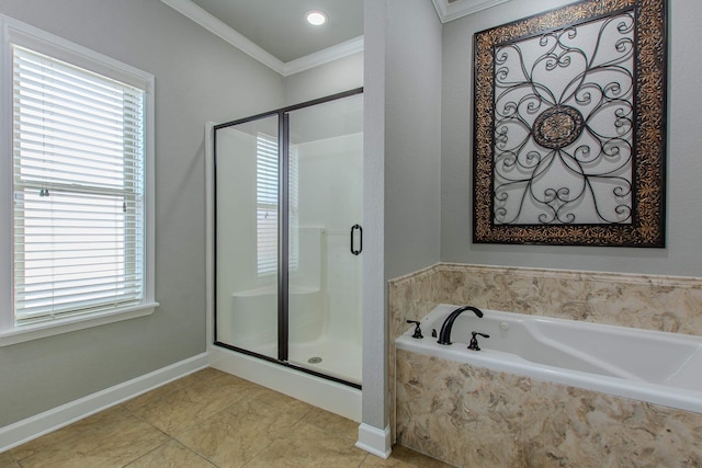 bathroom with ornamental molding and separate shower and tub