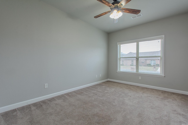 unfurnished room with vaulted ceiling, light colored carpet, and ceiling fan