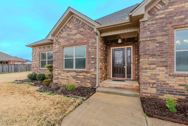 property entrance with a lawn