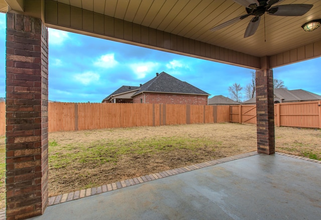 view of yard featuring ceiling fan and a patio area