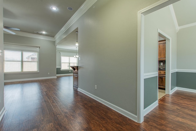 interior space with ornamental molding, dark hardwood / wood-style floors, and ceiling fan