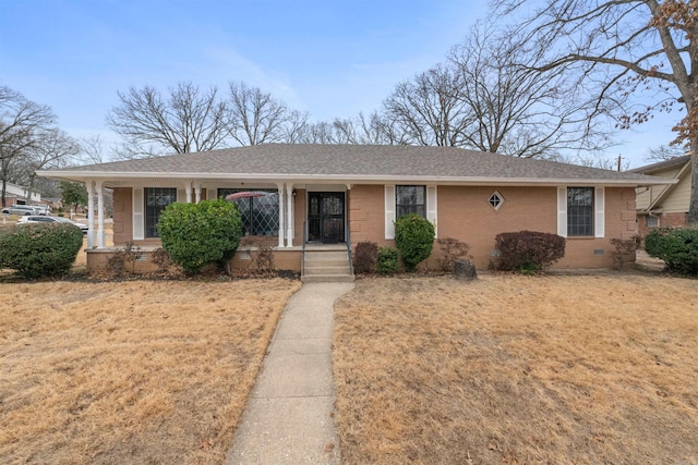 ranch-style house featuring a porch and a front lawn