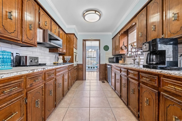 kitchen with light tile patterned flooring, appliances with stainless steel finishes, sink, backsplash, and ornamental molding