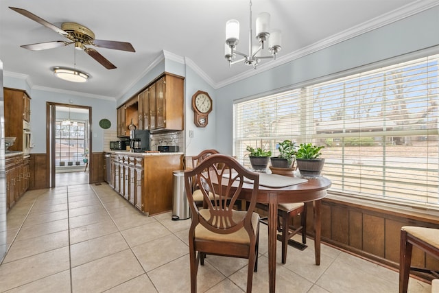 dining space with ornamental molding, a healthy amount of sunlight, and light tile patterned floors