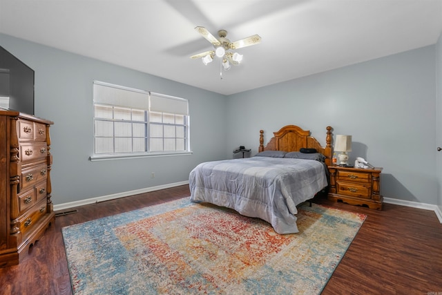 bedroom with ceiling fan and dark hardwood / wood-style flooring