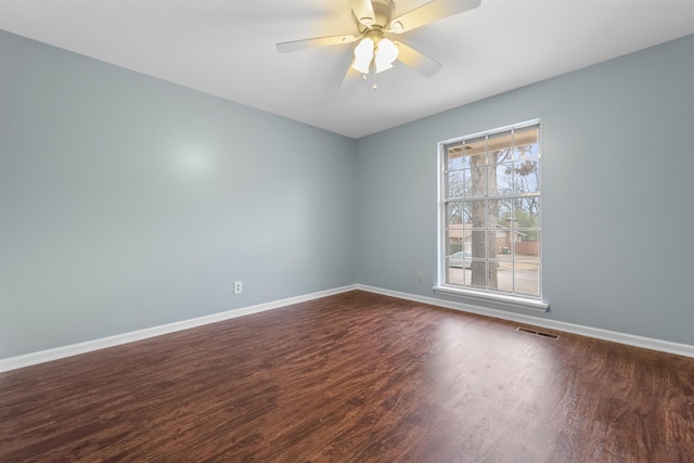 spare room with ceiling fan and dark hardwood / wood-style flooring