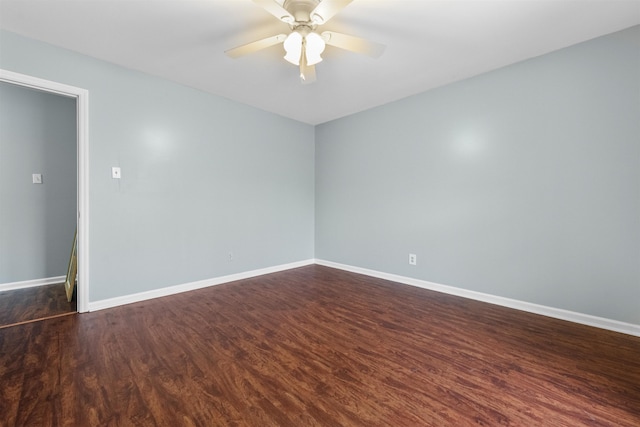 empty room featuring dark hardwood / wood-style flooring and ceiling fan