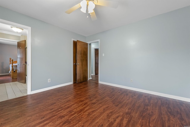 empty room with hardwood / wood-style floors and ceiling fan