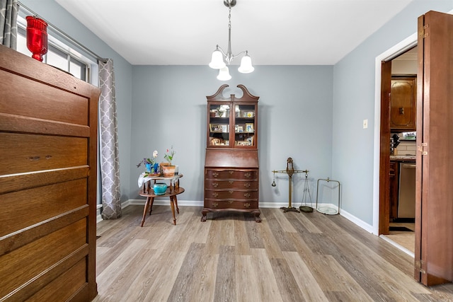 living area with an inviting chandelier and light wood-type flooring