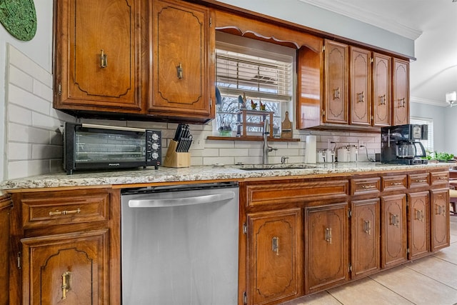 kitchen featuring a healthy amount of sunlight, backsplash, ornamental molding, and dishwasher