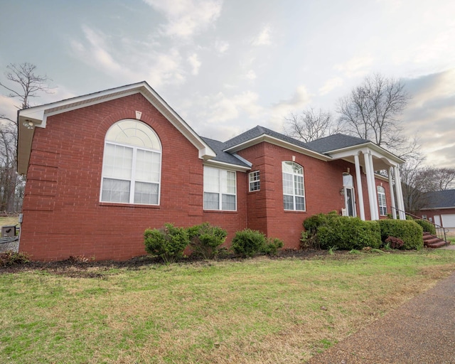 view of home's exterior featuring a yard