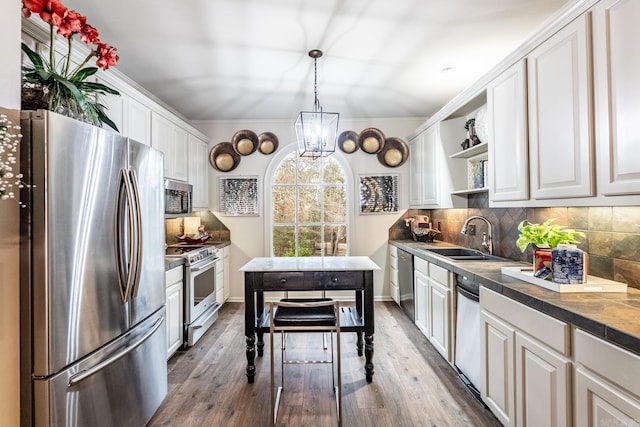 kitchen featuring tasteful backsplash, appliances with stainless steel finishes, sink, and white cabinets