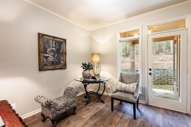 living area with dark wood-type flooring and ornamental molding