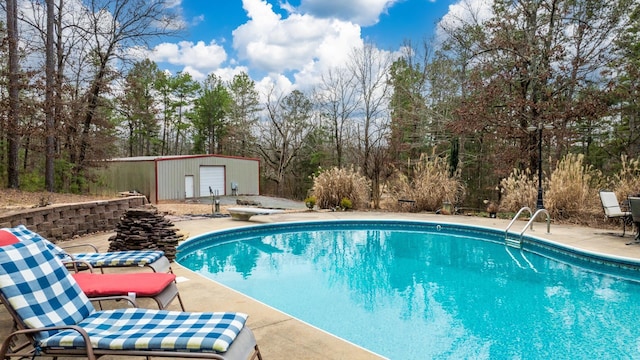 view of pool featuring an outdoor structure, a diving board, and a patio area