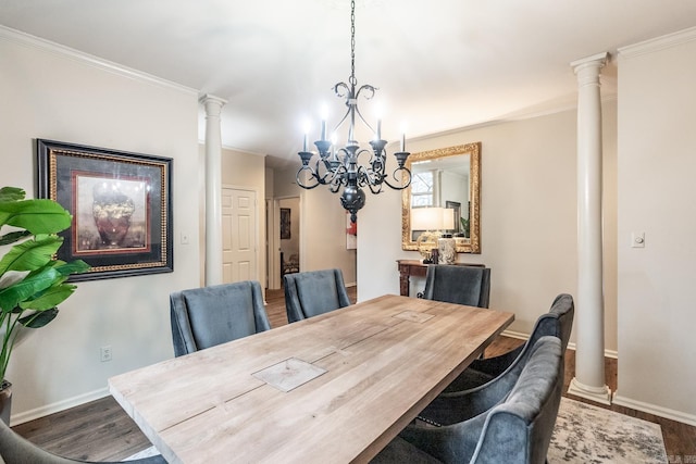 dining area with ornamental molding, dark hardwood / wood-style floors, decorative columns, and a notable chandelier