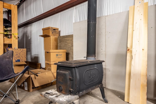 interior details featuring concrete floors and a wood stove