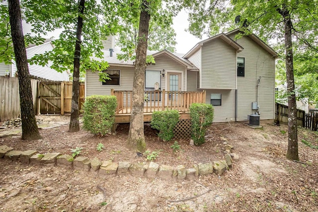 rear view of house featuring cooling unit and a deck